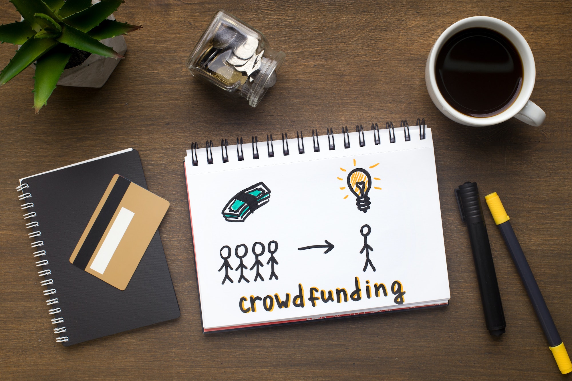 Drawing with crowdfunding concept in the notepad