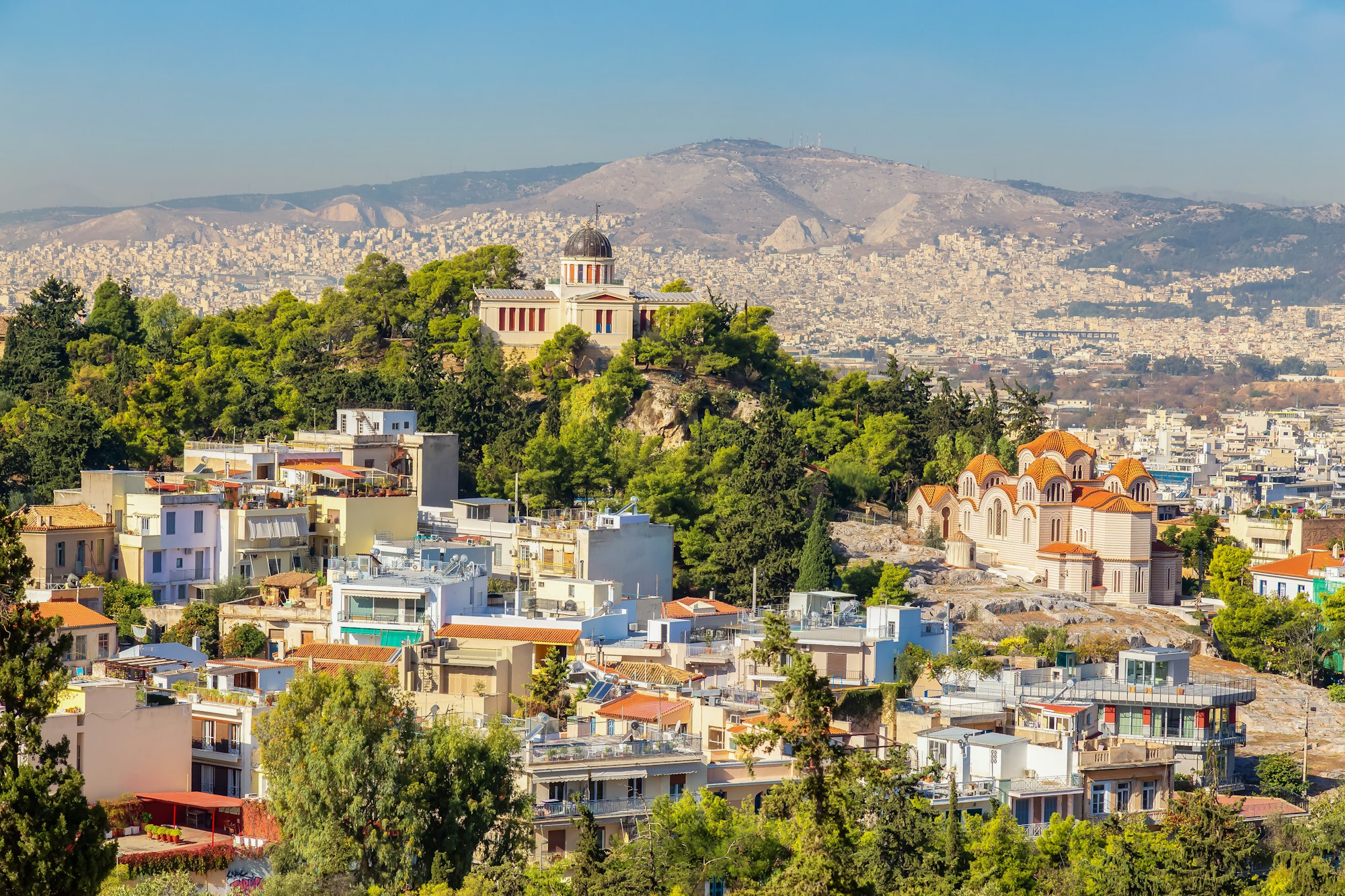 Residential Homes in a Historic City with Cityscape and Mountains. Areopagus Hill, Athens, Greece.